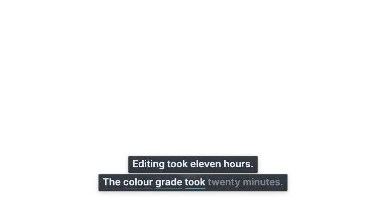 Caption Block — Burned-in landscape subtitles on two smoked-glass line plates, each word lighting as it is spoken with an accent trail behind the voice
