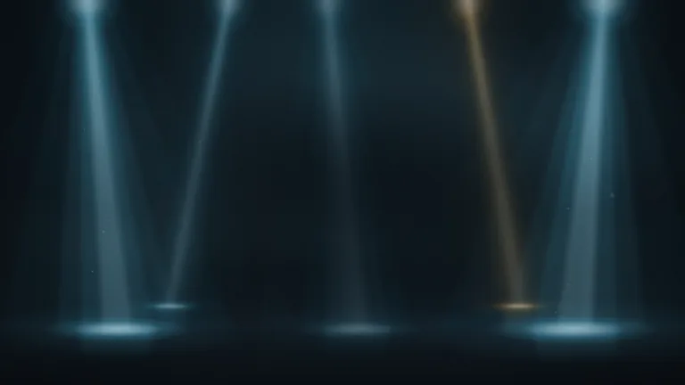 Light Beams Loop. Stage light beams falling from above through haze, with dust glinting in the light and glowing pools on the floor, as a seamless 10 second loop